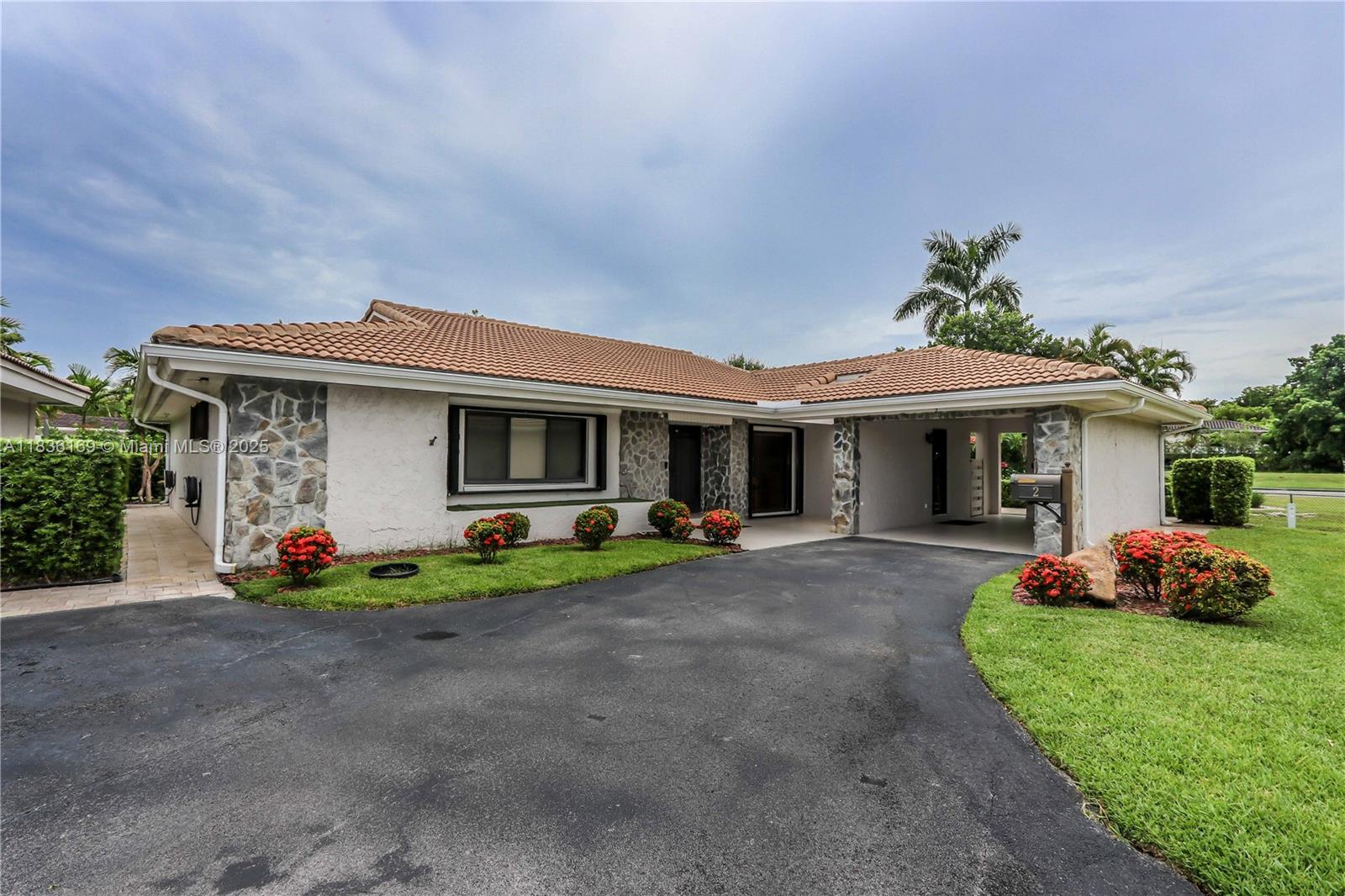 Beautifully updated 3 bed, 3 bath corner unit in a gated, private community with peaceful golf course views and no rear neighbors. This bright and spacious home features vaulted ceilings, crown molding, recessed lighting, and custom interior doors. Enjoy a custom kitchen with quartz countertops, stainless steel appliances, farmer’s sink, and ample cabinetry. Two primary suites offer flexibility and comfort. Impact windows and doors, plus hurricane shutters, provide peace of mind. Extras include a 1-car carport, wired surround sound and alarm system, tankless water heater (2024), 5-ton A/C (approx. 8 yrs), and newer tile roof (approx. 2 yrs). Laundry room with butler’s pantry adds function. Relax on your tumbled marble patio or at the community pool. A rare find!