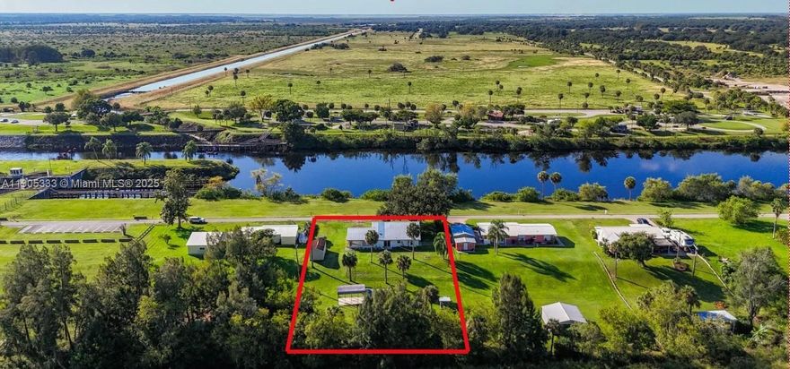 AFFORDABLE RIVERFRONT CHARMER – RETREAT OR RETIRE! CHANGE YOUR LIFESTYLE AND YOUR LIFE IN THIS TRANQUIL SCENIC SETTING! Nestled in rural Glades County on the Caloosahatchee River, part of the Intracoastal Waterway, connecting the Gulf of Mexico to the Atlantic Ocean. Enjoy panoramic water views, all types of boats traversing the locks for adventures from your spacious screened lanai overlooking the action! Fishing enthusiasts will love the free public boat ramp a short distance from your home. Fully renovated home is concrete block with a durable galvalume metal roof and boast double sliders front and back to blend the convenience of inside living with nature outside your door.