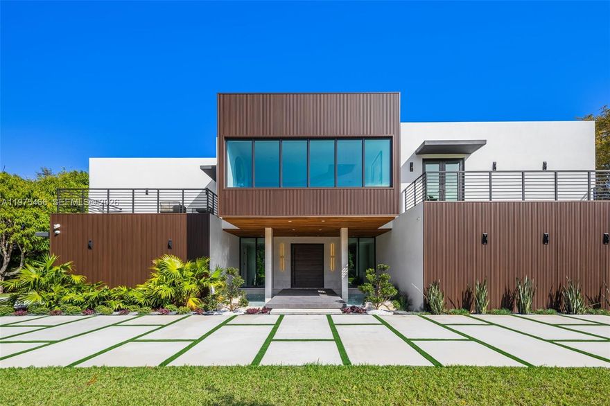 Welcome to a stunning new luxury home in the heart of Pinecrest. This expansive estate offers 8,673 sqft of living space with 7 beds and 7.5 baths in the main house, and a 1/1 guest house. Enter via a floating bridge flanked by water features, leading to elegant interiors with hardwood and tile floors, custom lighting, and a chef’s kitchen featuring premium appliances. The primary suite includes a custom walk-in closet, marble-clad bath, and a hidden safe room. A concealed media room adds flexible space for a theater, studio, or playroom. Additional features include a wine cellar area, elevator shaft, laundry room, and a private backyard with a pool, lighted tennis court, 3 balconies, and lush landscaping with fruit trees. This extraordinary home offers the ultimate in luxury and privacy.