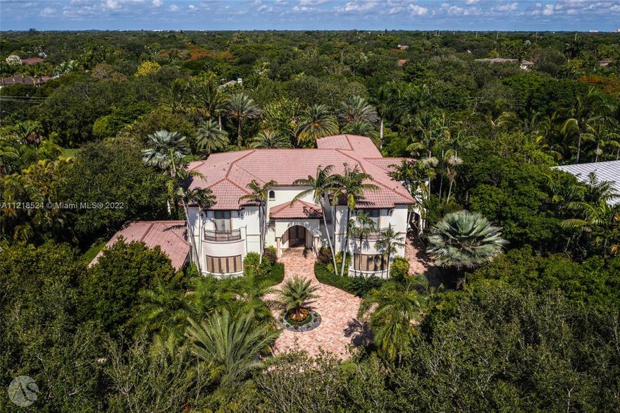 A prized property in the ultra desirable Pinecrest neighborhood. Situated on an acre+ lot, this grand Mediterranean estate boasts character and lush, mature landscaping creating true privacy within its gated setting. A 7 Beds, 7.5 Baths, Crestron-powered smart home w an elegant double height entry rotunda connecting the formal living, formal dining and an axis view to the pool beyond. The home has custom millwork throughout, a spacious gourmet kitchen, large pool w spa and 2 covered terraces w built-in bar, a large office, 3 car garage w an additional covered driveway w access to the kitchen. Exquisite primary suite with adjacent sitting area and terrace overlooking the pool. This attractive home is a dream backdrop for entertaining + enjoying peaceful evenings in the tropical backyard.