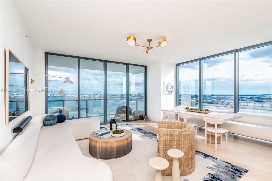 Breathtaking panoramic water and city views from every room of this spectacular SE corner 3 bed/4.5 bath + den  residence.  Boasting a total of 3100 feet of indoor and outdoor living spaces.  This designer finished, turnkey residence is featured in the January 2023 issue of Luxe Interior & Designs and again in the 2024 Luxe Gold issue.  European White Oak floors, custom crated wine and coffee bar, and intricate millwork compliment the soothing coastal palette of chic furnishings, floor to ceiling windows, wolf appliances, waterworks bath fixtures and more. 
Located at the edge of Biscayne Bay, Dlysee is Edgewater premier luxury boutique building at the nexus of world class art, design and culture.