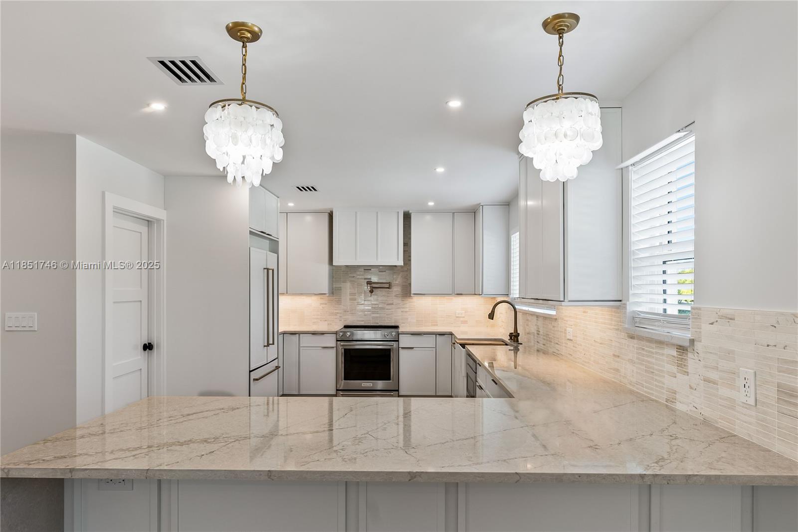 Luxury Waterfront Home in a Highly Desirable Boating Community. This fully renovated 3-bedroom, 3-bathroom en-suites CBS home, designed for modern coastal living. Every detail of this residence has been updated, including ALL NEW 2025 plumbing, electrical, and HVAC systems, ensuring worry-free ownership. A completely reimagined interior, featuring luxury finishes on a 75 ft wide canal. The open-concept design, with hurricane-impact windows and doors offering peace of mind. The chef's kitchen boasts premium appliances, custom cabinetry, and exquisite countertops, flowing into the spacious living and dining areas and coffee/wine bar feature. A durable metal roof adding to the home's longevity and appeal. This property offers deep water access from the 60 ft wide seawall (permit only).
