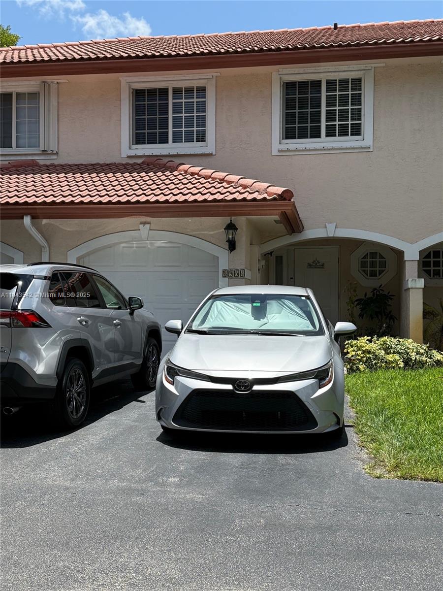 Don’t Miss Out! Perfect for First-Time Homebuyers! This 3-bedroom, 2.5-bath townhouse is ideal for a growing family. It features a 1-car garage with space for an additional vehicle, located on a quiet street in Coral Springs. The open floor plan on the main level includes a half bath, and upstairs you'll find tile flooring throughout. The master suite boasts vaulted ceilings, two walk-in closets, and a fully remodeled bathroom with a chic frosted glass shower. The home also includes hurricane impact windows and doors for added security. Enjoy the large screened-in patio, perfect for cookouts. Move-in ready and waiting for you!
