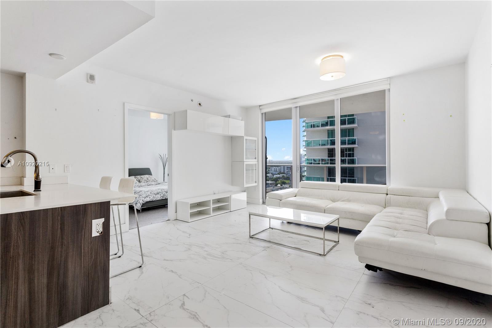 Bay & City views on 21st floor, 1Bed /1.5Baths, White Calacatta marble throughout living areas + balcony, carpet in bedroom, large outdoor living sized balcony, modern kitchen w/stainless Bosch appliances, Italkraft cabinets w/Quartz countertop & island/bar. Floor to ceiling glass doors, built-in closets, master bathroom w/double sink, Quartz countertop, tub & glass-enclosed shower. Washer/dryer in unit. 1 assigned parking space. Luxury amenities include Sunrise + Sunset resort pools w/bay views, jacuzzi, sauna, steam room, 3,500 SF State-of-the-art fitness center + Yoga studio. Brand new building located in the heart of prestigious Edgewater neighborhood designed by world-renowned Arquitectonica.