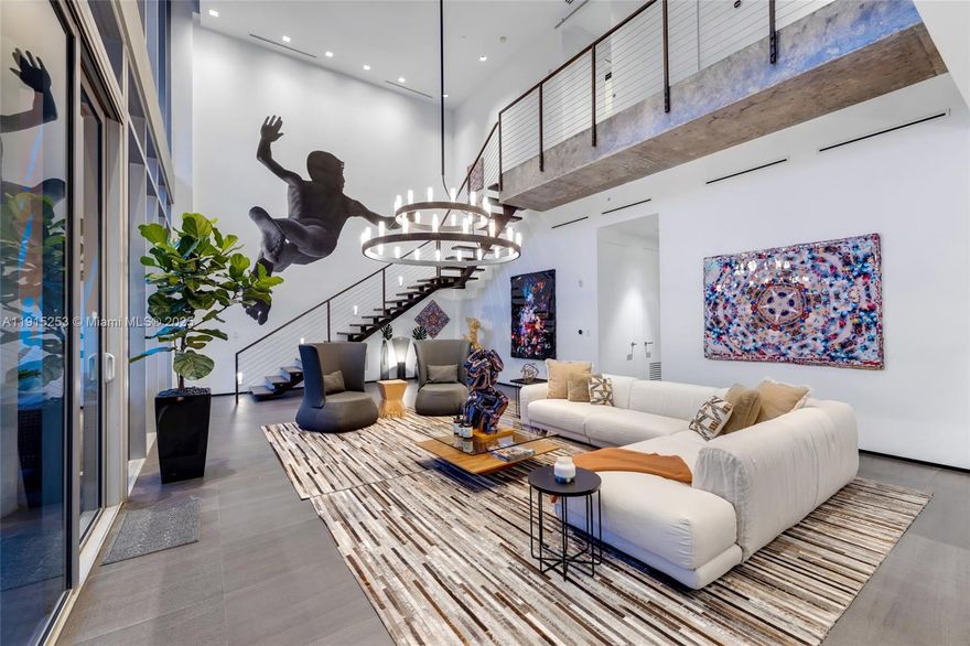 Experience Ático Wynwood, a spectacular two-level live/work penthouse in the heart of the Wynwood Art District. Featured as an ELLE DECOR Modern Life Concept House, this designer-curated residence blends modern luxury, flexibility and creative living. The 2,821 SF interior features a dramatic double-height living room and a custom Scavolini kitchen with Gaggenau appliances. Three spacious bedrooms, 3.5 bathrooms, and curated furnishings complete the home. The building’s exterior and lobby feature custom murals by prominent artists. Enjoy 2,500 SF of outdoor living with a vibrant private rooftop featuring a colorful canopy, professional bar, outdoor shower, multiple lounge and dining areas, privacy Clusia hedge, and sweeping Wynwood views.