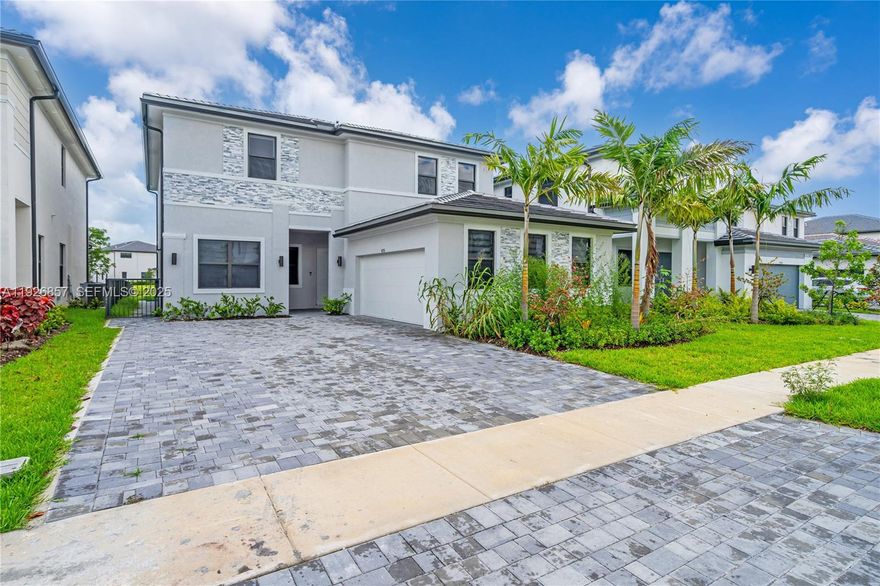 Gorgeous, modern smart home with stunning lake views in the gated community of Marbella. Features 10’ ceilings, open layout, tile on the 1st floor, and a sleek kitchen with island, quartz counters and SS appliances. Upstairs offers elegant vinyl floors, huge master suite with two custom walk-in closets, tub and shower, plus three bedrooms with walk-ins. Enjoy a covered terrace, paved patio, green yard and 7-seat hot tub. Includes a private guest suite with kitchenette and laundry. Two-car garage with large driveway. Community clubhouse with gym and pool. Near A-rated schools, Memorial Hospital Miramar, I-75.