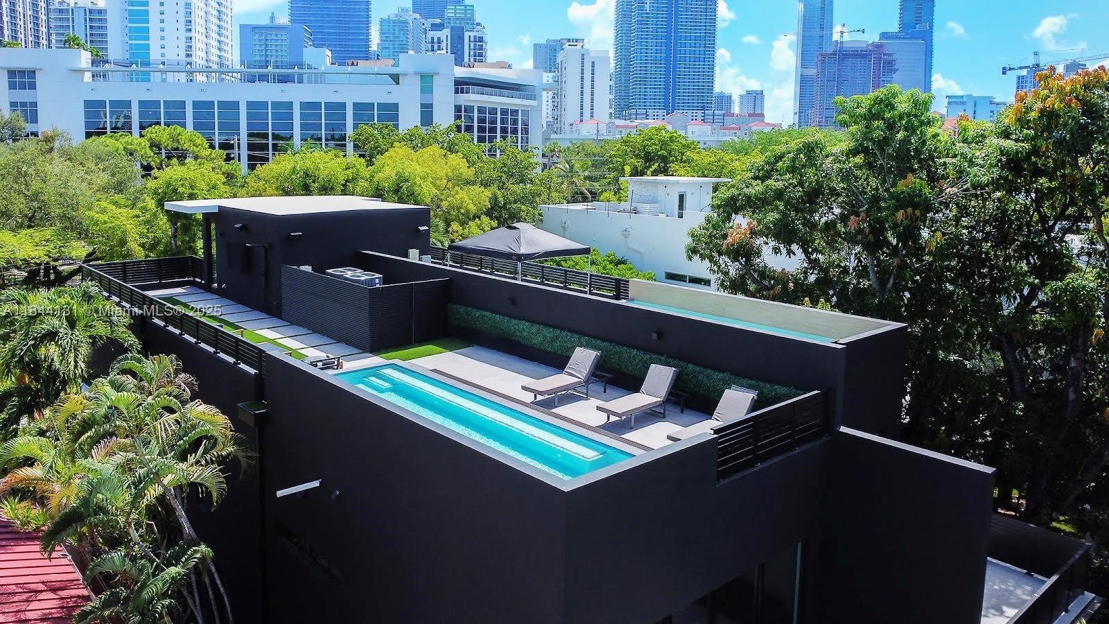 Experience the epitome of luxury living in just outside of Brickell, Miami's vibrant financial district and urban center. These exclusive residences offer an unparalleled lifestyle with exceptional design and premium features. Magnificent three-bedroom, three-and-a-half-bathroom residence that boasts 2,980 square feet of elegantly designed living space under A/C. The highlight of this home is the private rooftop terrace with a pool, offering panoramic views of Brickell's skyline. The master bedroom is a sanctuary, featuring a private garden patio, LED-lit closets, and integrated speakers powered by a Sonos amplifier. The second floor houses a spacious family room that opens onto a large balcony, perfect for entertaining or relaxing while taking in the urban vista.