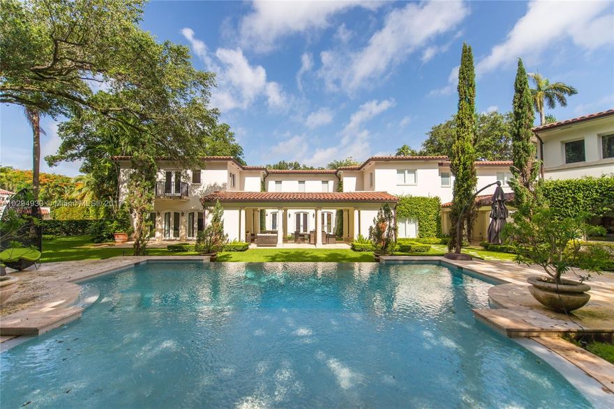 Stunning estate, situated on over 1/2 acre in The Moorings, an exclusive guard-gated bay front community in Coconut Grove. Total renovation in 2009 w/the finest finishes & fixtures throughout. Expansive light-filled rooms w/inlaid wood & stone floors, overlook lush tropical gardens & pool designed by award-winning Fernando Wong.  Spectacular state-of-the-art kitchen w/ mahogany cabinetry & large center island. Separate guest house & gym. Community dock/ Riparian rights & close to the Grove village.