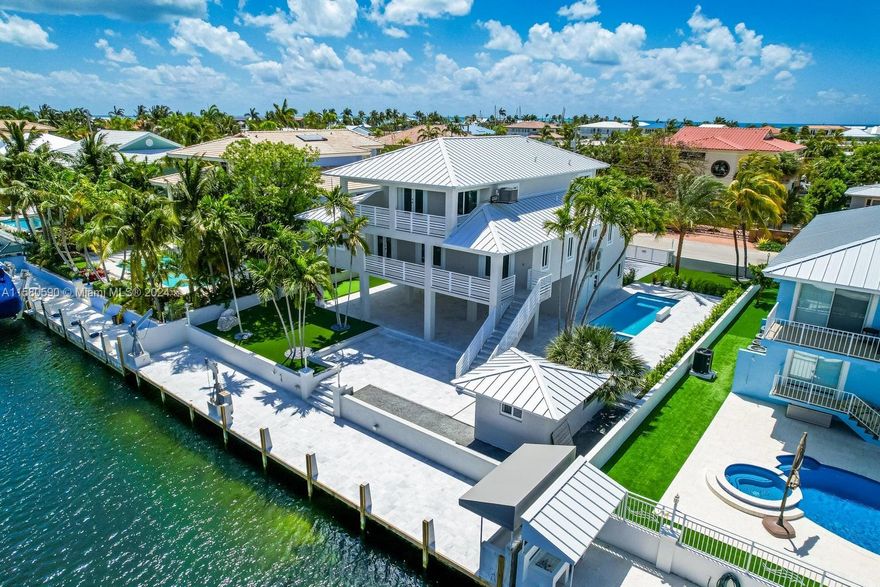 A modern waterfront island masterpiece, located in one of the finest locations of Key Largo, Port Largo. This concrete waterfront pool home, with 5 bedrooms and 3.5 baths has been completely and masterfully, transformed in 2023. OWNER FINANCING MAY BE POSSIBLE.  The finest and most luxurious features and amenities have been incorporated into this reimagined property, imparting a privileged ambiance in paradise, and yet is just a fast 1-hour commute from Miami International. The unyielding strength of concrete construction with all impact glass windows and doors will give you the peace of mind you are seeking in the Keys