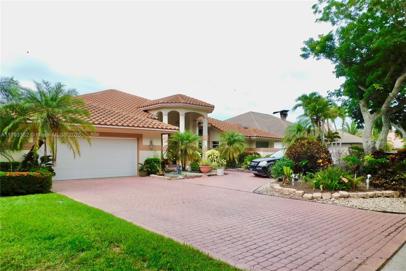 Located in the prestigious guard-gated Eagle Trace community. This stunning golf course and waterfront residence offers beautiful landscaping, circular driveway, and elegant double-door entry. Inside, soaring ceilings and expansive windows fill the home with natural light and showcase breathtaking views of the pool area, golf course and water. The spacious open-concept kitchen and family room feature rich wood cabinetry and granite countertops. The primary suite offers a generous layout and a luxurious style bathroom with a separate soaking tub and shower. Step outside to enjoy beautiful pool, BBQ and resting area and serene water and golf views—perfect for indoor/outdoor living. Eagle Trace is a non-equity golf course community w/low HOA fees!
