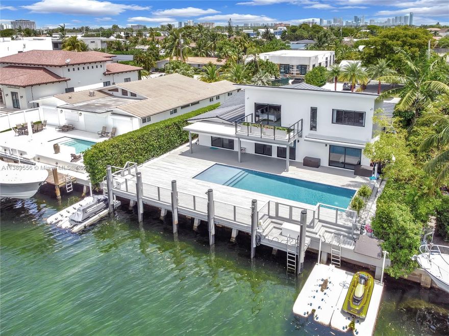 Welcome to an exquisite waterfront home in the prestigious San Souci Estates. This residence offers direct bay/ocean access, perfect for water enthusiasts. The open floor plan exudes grandeur with six bedrooms and bathrooms for privacy. The gourmet kitchen overlooks the living room and offers stunning water views. Outside, enjoy a heated pool, private dock boasting over 75 feet , and jet ski spaces. Parking is easy with a two-car garage and four-car driveway. The community is safeguarded by the 24-hour North Miami Patrol, and a tennis court center is conveniently located nearby. With wide bay views and over 3800 sq. ft., this attractively priced home is a prime choice.