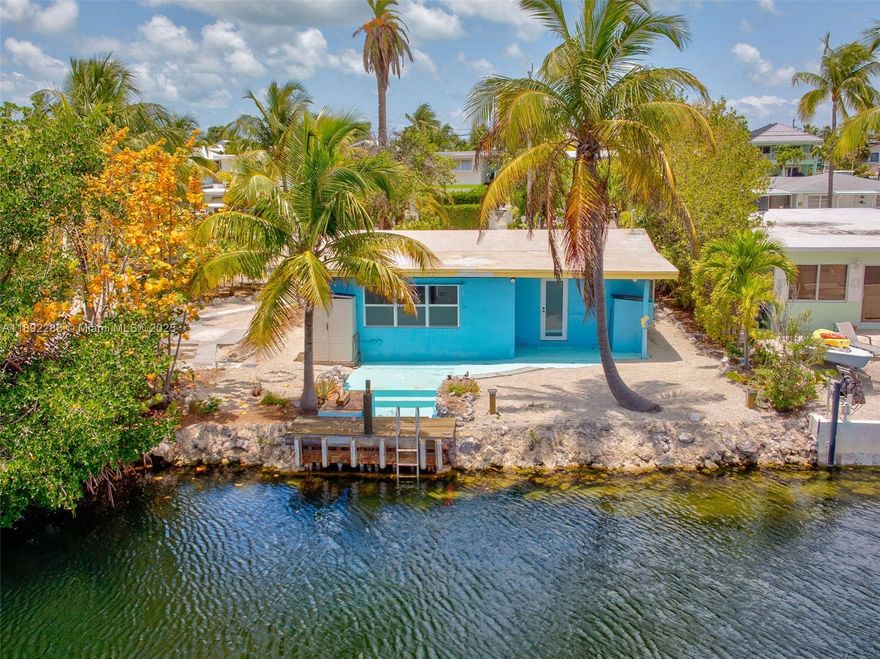 FUNKY KEYS PRIVATE WATERFRONT HIDEOUT ... keep existing home or rebuild on 50' of DEEP WATER canal, in peaceful & very desirable PLANTATION KEY COLONY. Owner financing possible! This inviting home offers a blend of character, comfort, and potential. The home's solid CONCRETE STRUCTURE, with impact-resistant windows/doors, provides security and serenity. This two-bedroom retreat is Ideally located in the heart of Islamorada. Highly rated schools Plantation Key School (K-8) and Coral Shores High School (9-12) nearby. Voluntary HOA w/ private bayfront homeowner's park, beach, truck/trailer parking, and boat ramp! Close and EASY ACCESS TO BAYSIDE AND OCEAN. Enjoy the getaway as is, remodel, rebuild. Inquire about the next door lot for sale - sold separately at $449,000!