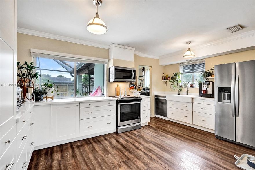 Welcome to this adorable 3-bedroom, 2.5 bath pool home located in the up-and-coming Riverland area of Fort Lauderdale.  Situated on a generous lot of nearly 7,900 square feet, this home features a beautifully screened-in pool area--perfect for entertaining family and friends.  Enjoy the convenience of an outdoor shower and poolside bathroom, ideal for guests.  The spacious open kitchen offers a bright white design with abundant cabinetry, stainless steel appliances , and a dishwasher, along with a pass through that fills the home with natural light.  The inviting living area feels cozy and welcoming as you step through the front door, while the separate dining room comfortably accommodates a large table for gatherings.  Additional highlights include impact windows and doors, a roof replaced in 2020, and a convenient carport.  This unique and charming home offers a relaxed, casual design and is ready to welcome its next happy home owner!