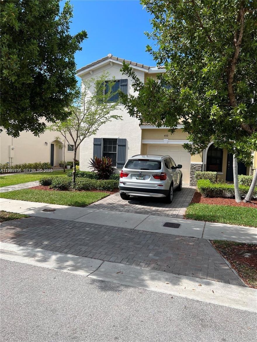 Corner townhome featuring the desirable Orchid model. This spacious residence offers tile flooring throughout, marble countertops in all bathrooms, and window blinds already installed. The home includes a full-size washer and dryer for added convenience. Enjoy the benefits of a covered garage with remote control access, plus an additional parking space in the private driveway. As a corner unit, the property provides enhanced privacy, with a side entrance and a grassy buffer separating it from the neighboring home. The first-floor bedroom includes a full bathroom—ideal for guests or multi-generational living. Conveniently located just one mile from a shopping center offering grocery stores, banking, fitness, and more. Residents also enjoy access to a community pool. One of the best values in the area for a 4-bedroom townhome. Don’t miss it—view the 3D tour for a complete walkthrough.
