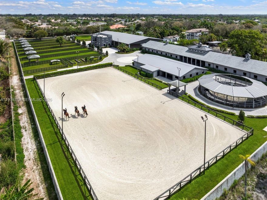 When only the best will do! This is not just an equestrian property — it’s a world-class show barn designed for riders operating at the highest level of the sport. The 5-acre gated facility offers longevity & elite performance just 40 minutes from Miami, 1 hour from Wellington & 30 minutes from Fort Lauderdale Beach.

The concrete barns feature 38 Rower & Rub stalls with premier footing, Nelson automatic watering systems, 24-hour surveillance & 16 run-outs. There are 12 oversized, irrigated grass paddocks with permanent concrete run-in sheds & fans for year-round comfort.

Broward County’s largest covered indoor arena (100' × 200') is complemented by a sprawling 175' × 275' outdoor arena, along with professional dressage mirrors, a hot walker, treadmill & dry treadmill. All stalls connect to a full underground drainage system designed to eliminate flooding.

A 3-story luxury clubhouse overlooks the arena and includes indoor/outdoor viewing areas, management offices, a bar, feed room, laundry room & a beautifully appointed tack room. Above is a 2-bedroom, 2-bath apartment ideal for a trainer or owner, plus a separate 3-bedroom staff apartment & full grooming facilities.

Direct trail access connects to Vista View Park and the Florida Trail network, and the property is conveniently located near American Heritage School.

New Price!