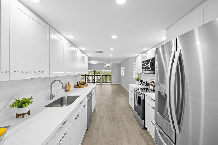 Experience the perfect blend of comfort and modern design in this beautifully updated 2BD/2BA corner unit with peaceful lake views. The new kitchen features ceiling-height custom wood cabinetry, quartz countertops, breakfast nook, stainless steel appliances and LED lighting. Waterproof vinyl flooring adds elegance throughout. The oversized primary suite includes a walk-in closet and remodeled en-suite with dual sinks. Both bathrooms have modern finishes, and zebra blinds add a stylish touch. Relax on the screened balcony with storage and serene views. Upgrades include new water heater and in-unit washer/dryer. Located in desirable 55+ Century Village with 24-hour gated security and resort-style amenities: clubhouse, fitness center, heated pools, tennis, theater, and shuttle. Move-in ready!