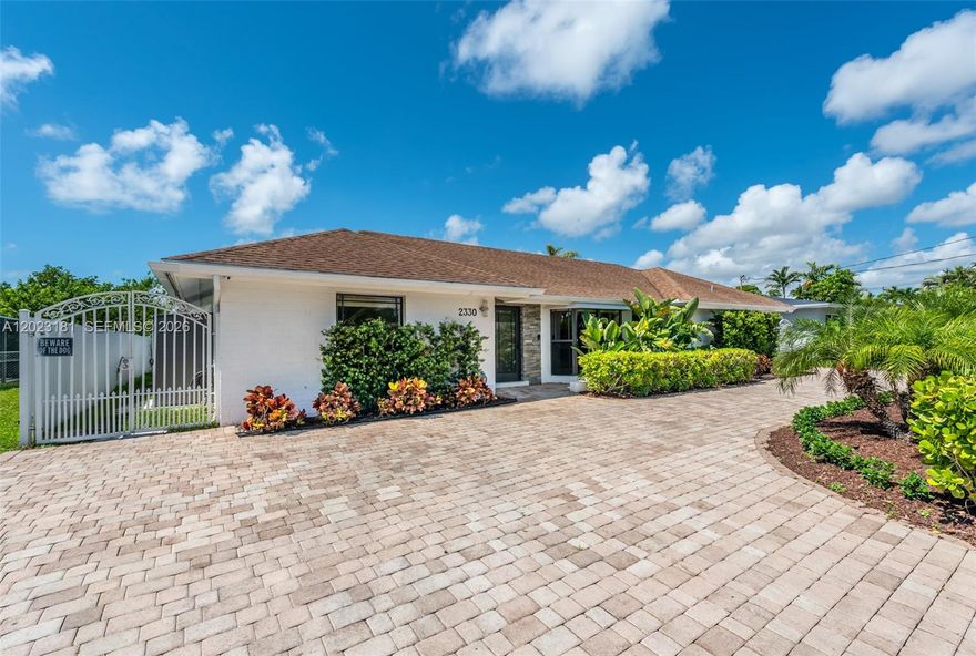 Prepare to be amazed by this stunning 5 bedroom, 4 bathroom canal-front home in the highly sought-after gated community of Enchanted Lake! As you step inside you'll be wowed by the ample space and stylish modern design. The marble floors, wood-beamed vaulted ceilings, high-impact doors and windows, and two A/C units are just some of the features that make this home stand out. Enjoy the pool view from your eat in granite kitchen boasting sleek appliances, and plenty of storage. The real showstopper is the backyard. The entire backyard is waterfront, making it the spot for endless outdoor fun and relaxation. Start your day with a refreshing kayak ride paddling down the calm waterways. The backyard is complete with a sparkling pool and entertaining deck! Don't wait to make this yours.