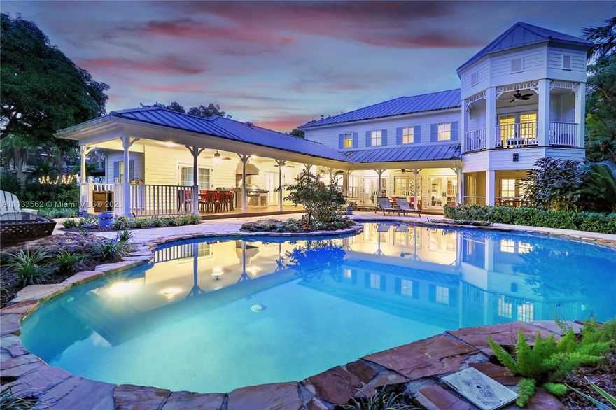 This gorgeous, updated 5 bedroom, 4.5 bathroom Key West-style estate is perfectly located in North Pinecrest.  Situated on a lush, 40,075 square foot lot, it features timeless design including wrap-around porches, formal living & dining rooms, huge family room, & updated eat-in kitchen with gas range, double ovens, & farmhouse sink.  The second-floor primary suite has a newly renovated bathroom with soaking tub, shower, & dual vanities, generous walk-in closet, & private balcony.  There are 3 additional bedrooms upstairs, one more downstairs, & a dedicated office.  Outside find large covered terraces, summer kitchen, free-form saltwater pool, & gorgeous yard.  Impact glass throughout, beautiful hardwood floors, laundry room, 2+ car garage, & too many more details to mention!