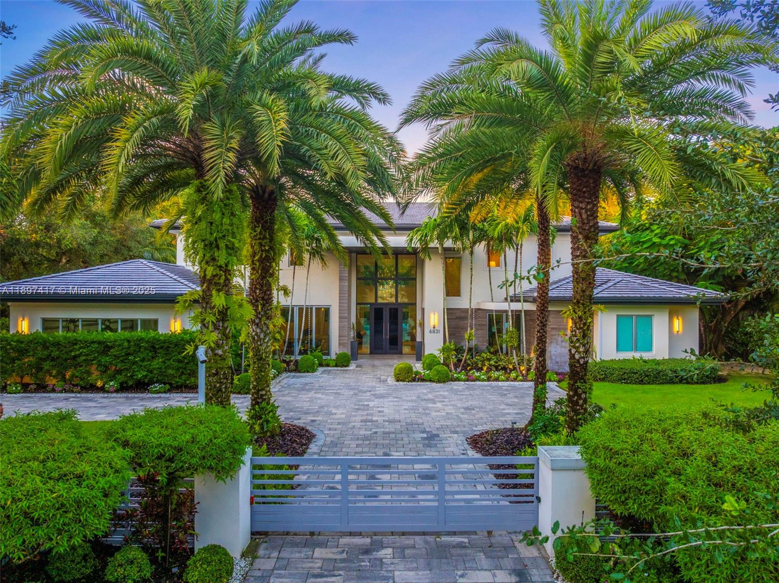 Just a 5-minute drive to Gulliver Prep and close to Miami’s top schools, this gated 6-bedroom, 7.5-bath modern estate blends sophistication with effortless livability. The home features soaring ceilings, dramatic windows, and impeccable design. Elegant living and dining areas flow into a chef’s kitchen with premium appliances, custom cabinetry, and a spacious island for gatherings or entertaining. Five en-suite bedrooms include a primary suite with dual walk-in closets, spa-like bath, and private balcony. A home theater, wine cellar, office, and integrated smart-home technology elevate everyday comfort. Outdoors, a tropical oasis with multiple covered terraces designed for year-round entertaining. A beautifully finished 1-bedroom, 1-bath guest house provides a private retreat for visitors.