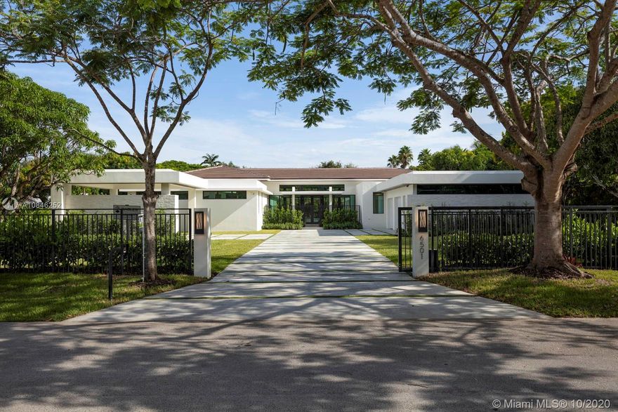 This stunning light and bright brand new modern home in sought after N Pinecrest is ready to move in! High ceilings and an inviting fireplace greet you as you open the front door. A beautiful mango tree outside, frames the dining room windows perfectly. This is a great open floor plan for families and entertaining.The Home is equipped with Subzero and Wolf appliances. Home has an amazing covered outdoor summer kitchen and stand alone in-law quarters, perfect for any kind of use. The master closet will impress any shopoholic! The pool and jacuzzi is stunning and will host lots of family and friends. This home is located on a cul-de-sac street and is gated and fenced. 3 car garage plus 2 vehicle carport! 2 covered terraces.