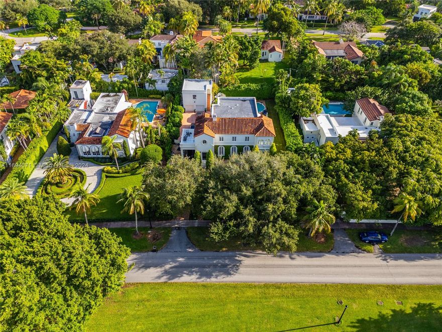 Overlooking the serene 2nd hole of the Granada Golf Course, this stunning Palm Beach-style residence in the heart of Coral Gables is the one you’ve always loved. Built in 1925, this iconic 7 BR, 5.5 BA home offers 5,302SF of refined living space on a 16,400SF lot. The home welcomes you through an oversized foyer then opens into formal living & dining rooms, a cozy family room, & a sunroom brimming with natural light. The spacious kitchen & convenient laundry room complete the 1st floor. Upstairs, discover 4 oversized bedrooms, including the luxurious primary suite w/ updated bath & walk-in closet. There is also a detached garage w/ a charming 2-bedroom guesthouse above. Nestled blocks from Miracle Mile & Coral Gables Country Club this residence offers a prime location & timeless elegance.