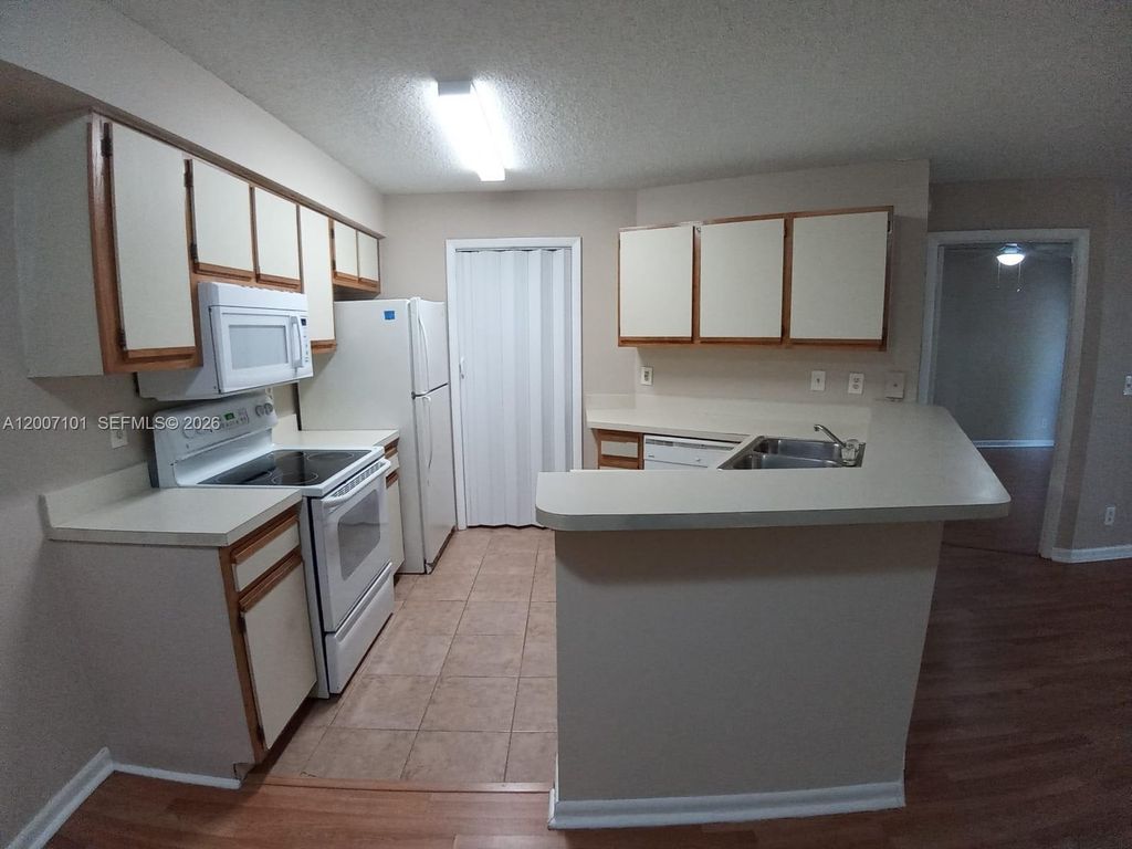 Photo of 9999 Summerbreeze Dr #504, Sunrise, FL 33322 (MLS # A12007101)