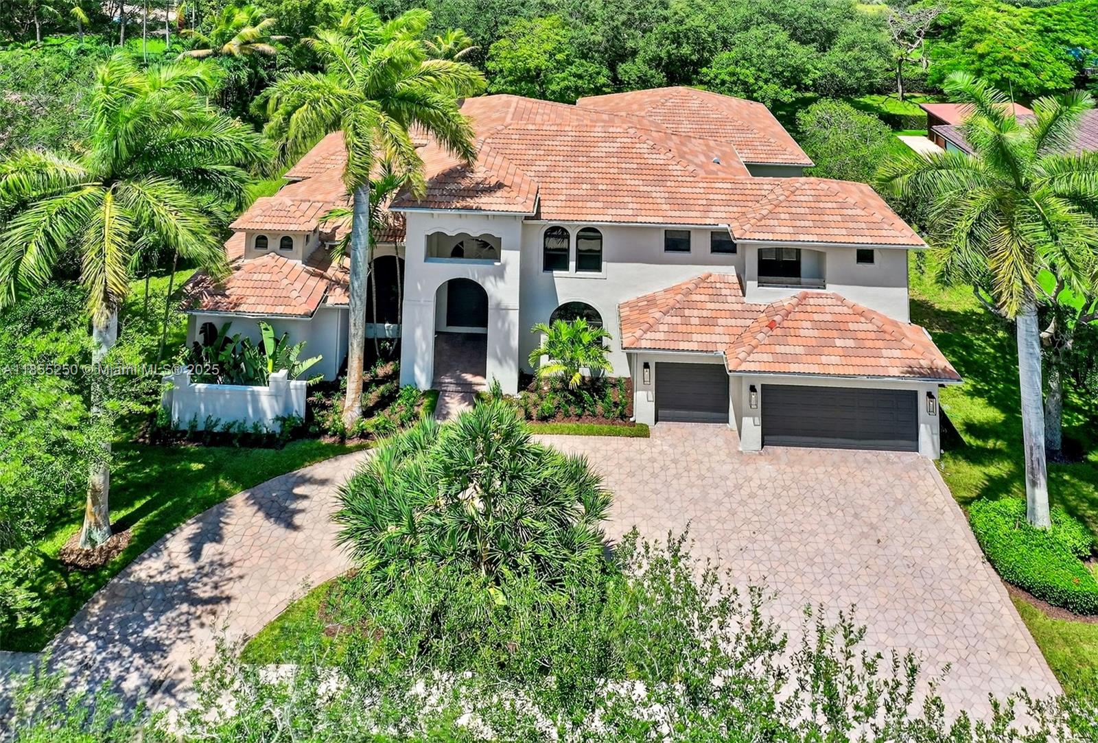 Stunning & fully remodeled home nestled in one of the most sought-after gated communities in Davie. Every detail was well thought out with impeccable taste. Over 5,000 sqft of living area featuring 5 beds, 6 full baths, an elegant glass door office & theater room. Get greeted by high ceilings & natural light. The floor to ceiling fireplace wall creates a striking focal point. Beautiful gray porcelain floors & wood-look tile upstairs. All new impact windows. New gourmet kitchen featuring a seamless design with Led lighting, porcelain countertops perfectly matching the custom wooden cabinets. Primary suite featuring an endless walk-in closet that leads to the flawless master bath. Modern Built-in wine display & custom bar perfect to entertain. Spacious backyard featuring a new summer kitchen