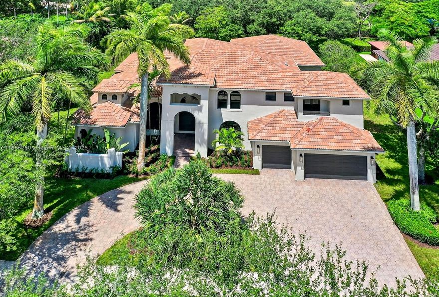 Stunning & fully remodeled home nestled in one of the most sought-after gated communities in Davie. Every detail was well thought out with impeccable taste. Over 5,000 sqft of living area featuring 5 beds, 6 full baths, an elegant glass door office & theater room. Get greeted by high ceilings & natural light. The floor to ceiling fireplace wall creates a striking focal point. Beautiful gray porcelain floors & wood-look tile upstairs. All new impact windows. New gourmet kitchen featuring a seamless design with Led lighting, porcelain countertops perfectly matching the custom wooden cabinets. Primary suite featuring an endless walk-in closet that leads to the flawless master bath. Modern Built-in wine display & custom bar perfect to entertain. Spacious backyard featuring a new summer kitchen