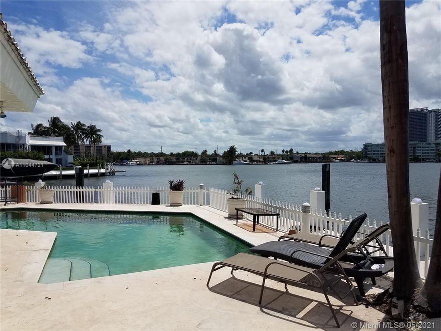 Great opportunity to purchase rarely available Eastern Shores Home on the wide water. (Approximately 5,100 LA sq ft on 9,710 sq ft Lot ) Smack on the Maule Lake waterway. Approx.150 feet on the water front. Dock your large boat/yacht with ocean access & no fixed bridges to Haulover Inlet. This modern style 2 story home features entry level with spacious eat-in kitchen w/ Wood cabinets, granite counter tops, large island  and Thermador Gas Stove. Additional rooms on entry level include 3 bedroom 2 bathrooms, 2 half bathrooms, laundry, Florida room with bar, Living room, and Dining room area. Second story has super spacious Master bedroom, bathroom and large walk-in closet. Also an additional bedroom and bathroom.
24/7 Guard-Gated. Located just minutes to the beaches of Sunny Isles. .