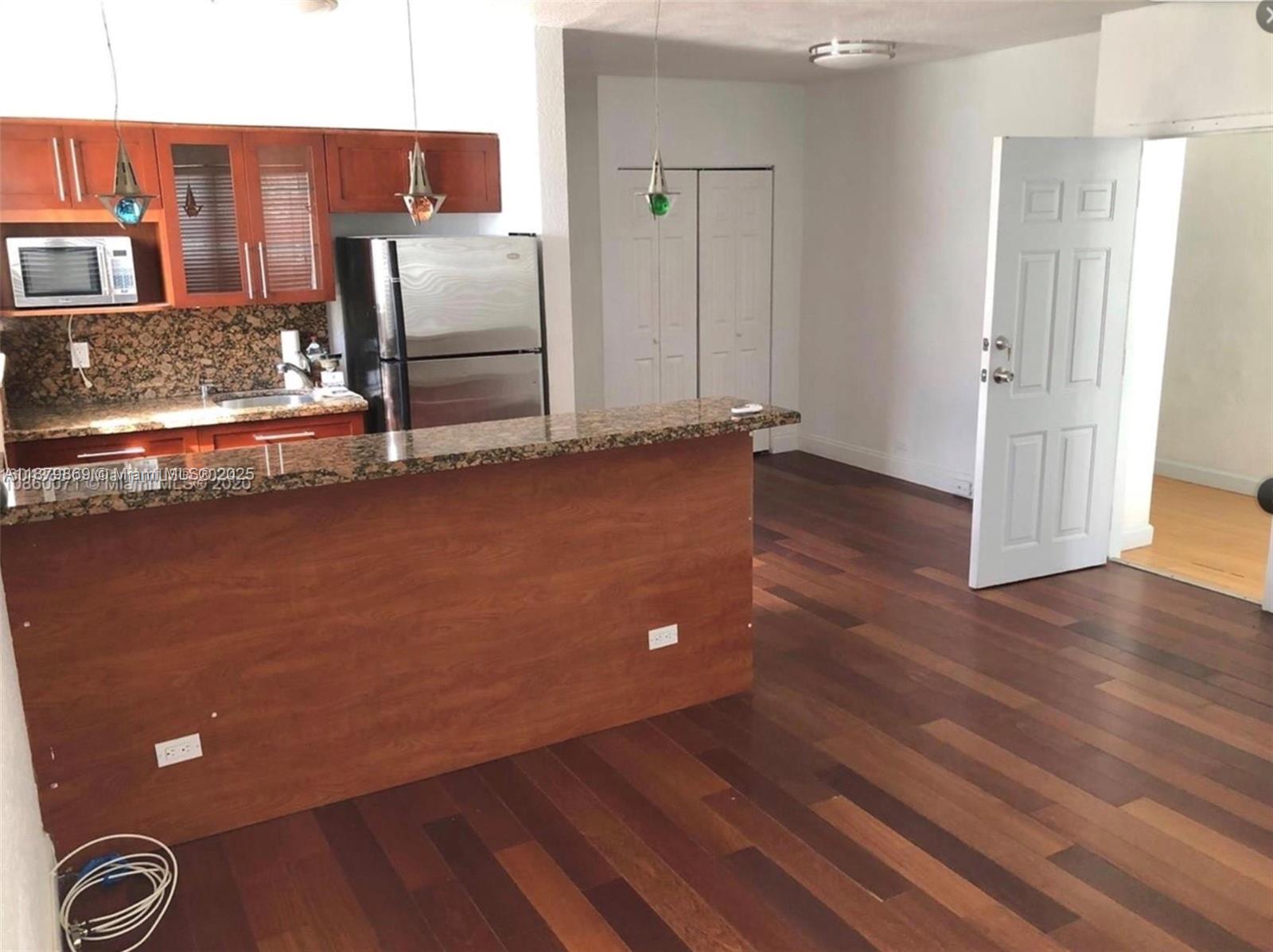 LOCATION- Corner unit-Walking distance to the beach, restaurants, shops, banks, etc... unit has laminated wood floors throughout the entire unit, kitchen and bathroom completely updated with granite countertops, stainless steel appliances, GAS STOVE.