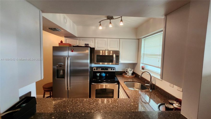 55+ Remodeled throughout 1 bedroom 1 bath condo in East Boca Raton! Updates include newer patio door and windows, electric panel, kitchen appliances. Bathroom has a window, roll-down shutters in the screened in patio. Popcorn removed/refinished ceiling, wood/tile floors, newer vanity and fixtures. W/D in unit.  Conveniently located close to the elevator. Palm Royal Apartments Inc is a quaint community settled within minutes from Mizner park, shopping and restaurants. Publix is literally around the corner, easy access to the beach. MOVE IN READY!  Building completed 40 y inspection, new roof installed in 2025, wiring updated, all special assessments have been paid by the seller.