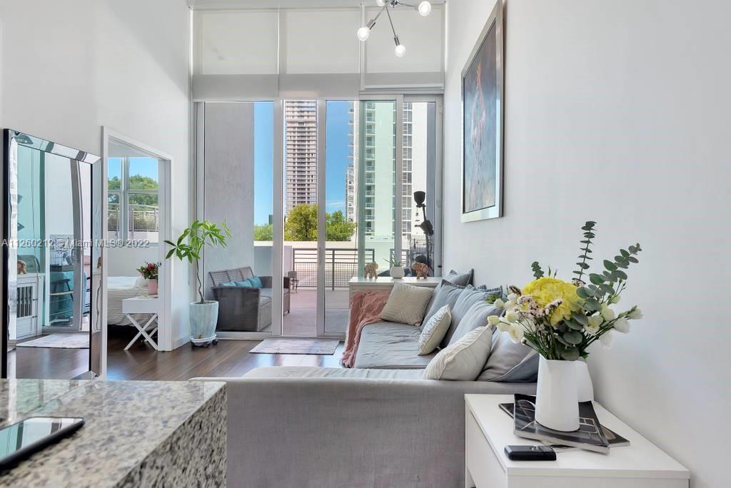 1 bed/1 bath + Den (Additional small bedroom) could be used for an office or kid's room. Loft with partial bay views and large patio. Renovated, modern decor, high ceilings, kitchen stainless steel appliances, and granite countertop. Washer & Dryer in unit. Building amenities include pool with pool deck and jacuzzi, sauna room & gym. Accessibility to public transportation, and close to Downtown, Wynwood and Midtown. Ready to move-In, beautiful unit. Rent includes 1 assigned parking space.