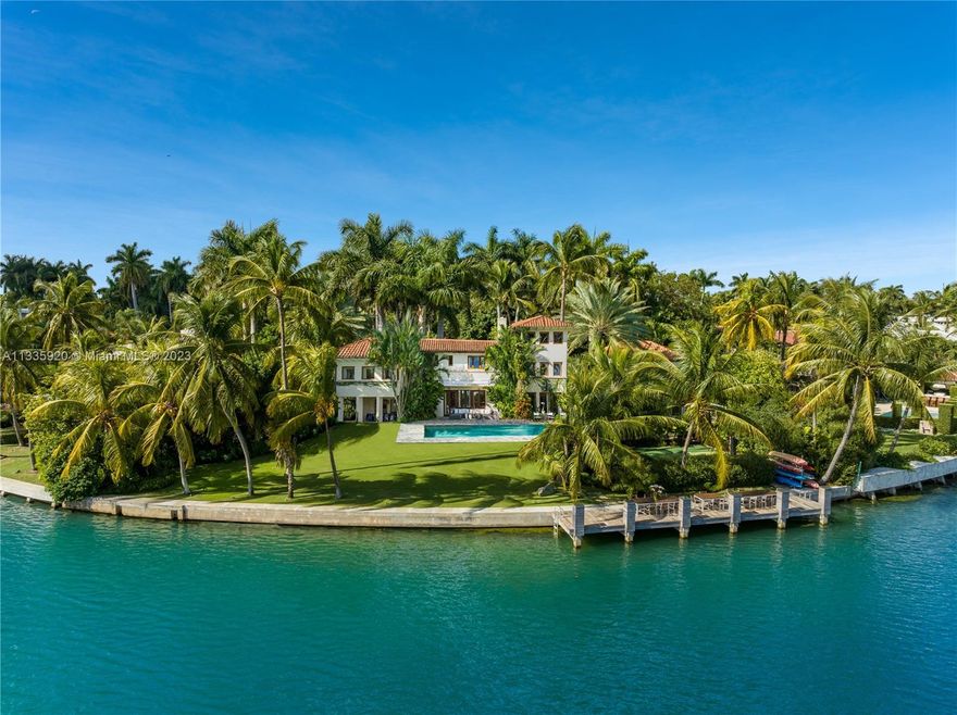 Nestled on prestigious Sunset Island II, lush, tropical pathways lead to this luxurious estate, a serene haven of contemporary design. With the masterful touch of renowned architect Walter Chatham & interior designer Julie Hillman, this Old Spanish home has been meticulously transformed into an oasis. The principal bathroom was designed by the late iconic architect, Zaha Hadid. Boasting 163’ of WF, the 2-story home sits on a 25,769 SF lot. Gourmet kitchen is a chef's dream w/ La Cornue wall rotisserie, Miele wall oven, Wolf gas range & marble countertops. The outdoors feature a heated pool, half basketball court, private dock & dining spaces. The estate also has a detached guest house & 2-car garage. Recognized in Architectural Digest, it's one of South Florida's most sought-after estates.