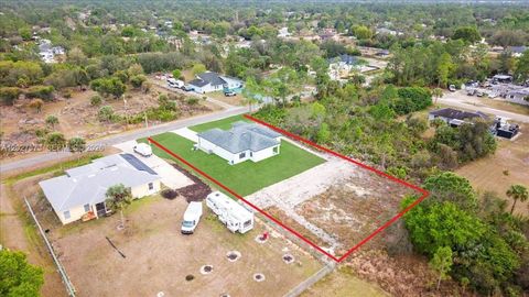 Photo of 705 8th Ave, Lehigh Acres, FL 33972 (MLS # A12027873)