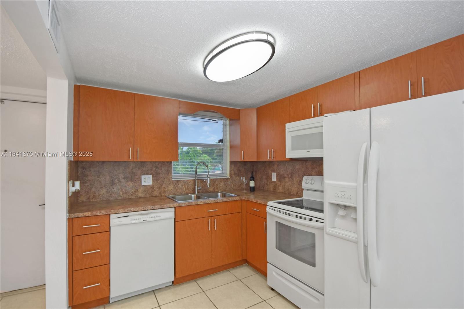 Welcome home! This charming 55+ apartment offers 1 bedroom and 1.5 bathrooms, with recent updates including kitchen hardware and upgraded light fixtures. Water and basic cable are included, and a convenient common laundry room is steps away on the same floor. Large impact windows fill every room with natural light. Enjoy your enclosed balcony overlooking the garden and pool—featuring white brick walls, a ceiling fan, and ventilated windows, perfect for relaxing. The spacious bedroom includes an extended vanity and a walk-in closet. The building has recently undergone major renovations, including a new roof, elevator, and fresh paint. Enjoy resort-style amenities: pool, billiards, tennis courts, BBQ grills, and more. Experience tranquil South Florida living today!