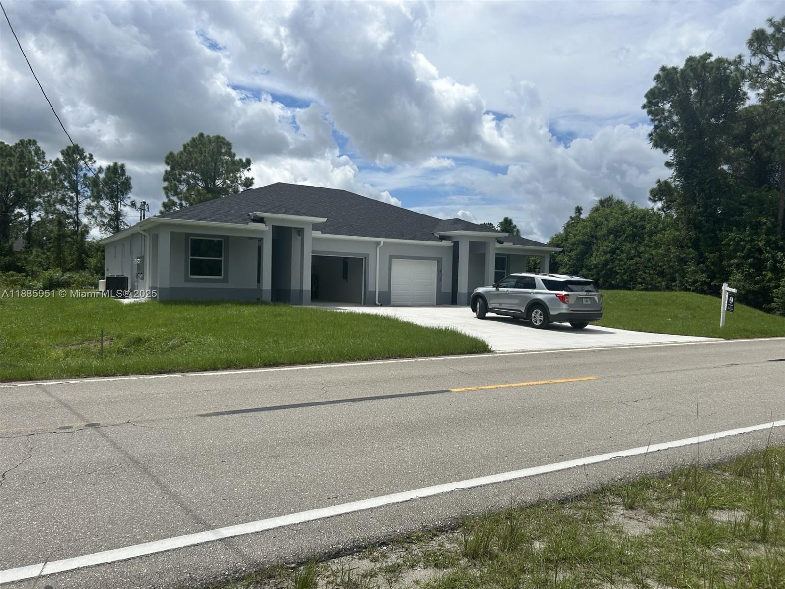 Step into modern, effortless living at this pristine 2025-built duplex, situated on 200/202 E 12th St in the rapidly expanding Lehigh Acres community. Each mirror-image unit features three generously sized bedrooms and two bathrooms outfitted with high-end fixtures and elegant finishes. Sunlight floods the open-concept kitchens and living areas, where sleek cabinetry, premium appliances, and stylish countertops invite both everyday meals and entertaining. Every bedroom offers a finished closet, enjoy the convenience and security of a private attached garage. Built for quality and comfort, the home's features include durable block-and-stucco construction, tile flooring throughout, impact-resistant windows, a water softener, well water and septic setup. Set on a spacious 0.24-acre lot