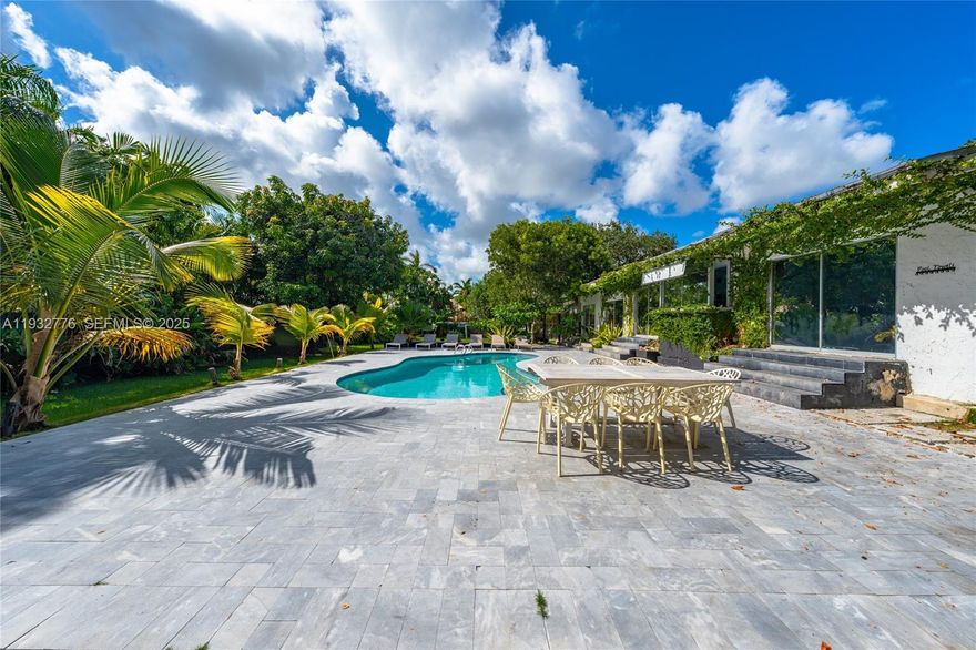 A rare opportunity on an expansive half-acre in Miami. Fully renovated and thoughtfully designed, this unique residence blends architectural character with modern functionality. Soaring 14-foot vaulted ceilings create a dramatic sense of space, while a beautiful pool and open layout make the home ideal for entertaining. Offering 5 rooms and 4 bathrooms, the flexible floor plan allows for multiple living areas, perfect for multi-generational living, guests, or income-producing use. Airbnb is fully permitted with reports available. Private, serene, and conveniently located near Miami’s top destinations, this property delivers exceptional lifestyle and investment potential. Buyer to verify square footage, room count, and use. Property was originally a 3-bedroom, 2-bath home and has since been reconfigured.