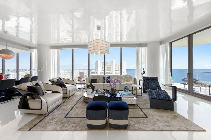 Ascend to a new level of luxury w/ this one-of-a-kind Bugatti Residence in the Sky. Perched high above the coastline, this 4,450-square-foot masterpiece captures sweeping, cinematic views—sunrise over the Atlantic to the east, & golden sunsets over the city skyline to the west. World-renowned interior designer Ricardo Britto curated each space with intentionality, layering exquisite textures, Ettore Bugatti’s signature Bleu flows elegantly throughout the 4 bedrooms and 5 bathrooms residence. In the dining area, history and innovation converge as automotive-grade carbon fiber reimagines Carlo Bugatti’s iconic 1902 Cobra Chair. In the great room, Italian-crafted furnishings, & masterful architectural details. This isn’t simply a home—it’s a collector’s dream. A trophy in the sky.