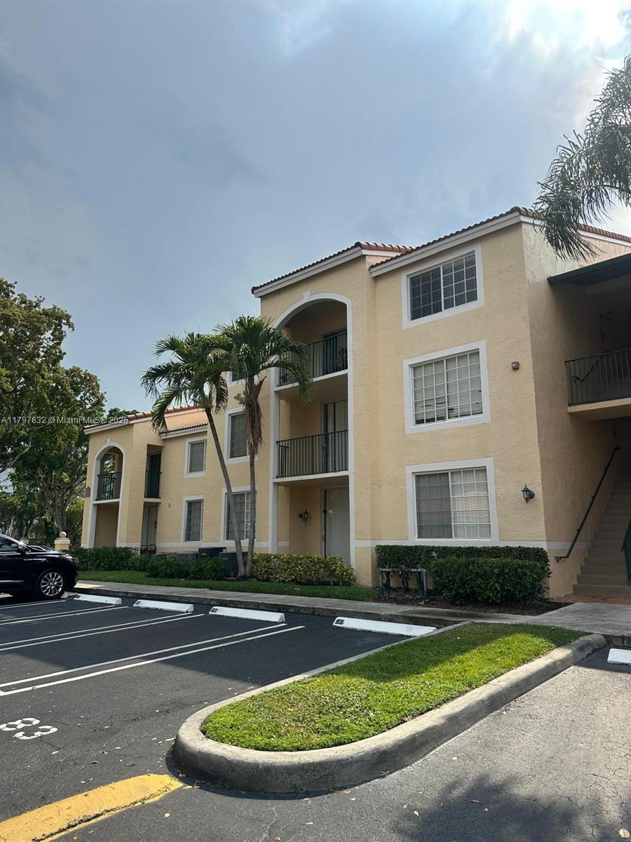 Welcome to Milano, an extremely desirable gated community offering exceptional resort-style amenities. This well-maintained 1-bedroom, 1-bath corner unit features vaulted ceilings, abundant natural light, and a new A/C. Enjoy lush tropical landscaping and a tranquil pool view from your covered balcony. The unit offers private corner access, a walk-in closet, and scenic views of the tennis courts and garden area. Includes one assigned parking space for added convenience. Ideally located near the Village Shopping Center and just minutes from the new Palm Beach Outlets and vibrant downtown West Palm Beach. Community amenities include a clubhouse, resort-style pool, fitness center, and more.