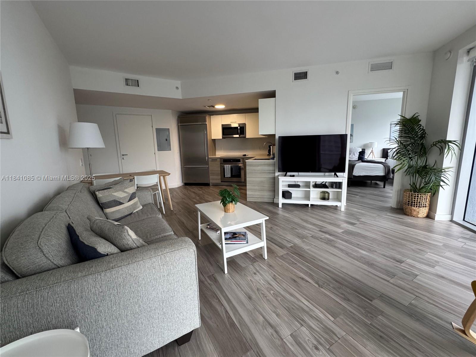 2 Master Suites in a split floor plan, with floor to ceiling impact windows. The unit features an open concept floor plan with custom kitchen, imported European cabinets, stainless steel appliances, walk-in closets, ceramic floors wooden look alike and electric blinds and shades. Enjoy the extra-large balcony. Resort-style amenities including two pools, spa, BBQ area, gym, theater, and kids' playground. Prime location in the financial district.