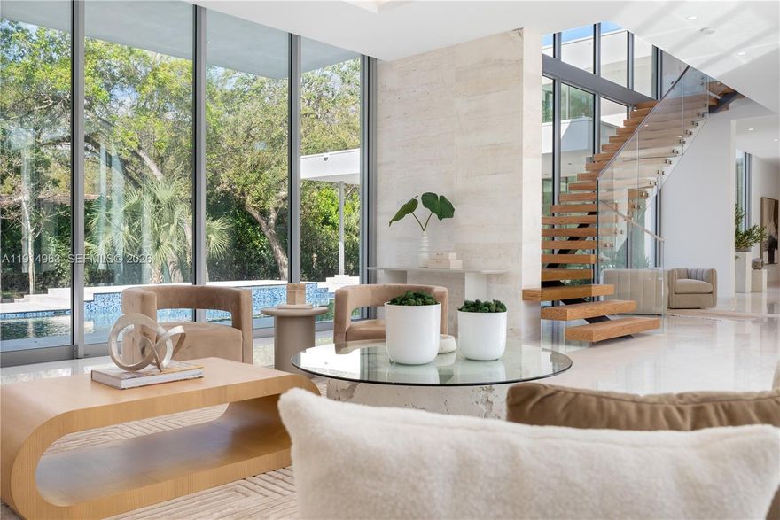 Villa Acqua di Gioia in the heart of North Pinecrest, blends modern sophistication with serene privacy on a prime corner lot. This 11,255 SqFt home includes 7 bedrooms and 7.5 baths, featuring soaring ceilings and retractable 12-foot sliding glass windows for seamless indoor-outdoor living. Designed by Balli Architecture, it boasts luxurious amenities, including a resort-style pool, infinity edge jacuzzi, elevator, a spacious 3 car garage and marble floors throughout.  A media room provides entertainment, while a standalone gym or in-law quarters with a private bathroom offers added convenience. Culinary enthusiasts will love the Italian kitchen by Pedini with a gas stove and high-end appliances. With 2 independent entries, this estate epitomizes luxury living in a tranquil setting.
