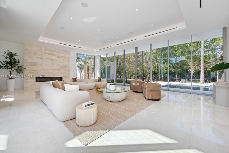 Villa Acqua di Gioia in the heart of North Pinecrest, blends modern sophistication with serene privacy on a prime corner lot. This 11,255 SqFt home includes 7 bedrooms and 7.5 baths, featuring soaring ceilings and retractable 12-foot sliding glass windows for seamless indoor-outdoor living. Designed by Balli Architecture, it boasts luxurious amenities, including a resort-style pool, infinity edge jacuzzi, elevator, a spacious 3 car garage and marble floors throughout.  A media room provides entertainment, while a standalone gym or in-law quarters with a private bathroom offers added convenience. Culinary enthusiasts will love the Italian kitchen by Pedini with a gas stove and high-end appliances. With 2 independent entries, this estate epitomizes luxury living in a tranquil setting.