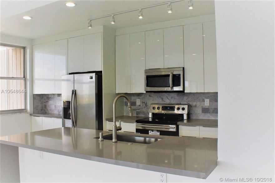 All Ages Welcome! Beautifully renovated & upgraded 2Bed/2bath Deluxe corner overlooking the city. Fully remodeled with porcelain white floors throughout. Open kitchen with brand new white cabinetry with grey quartz countertops. New stainless steel appliances. Spacious master bedroom suite with huge walk-in closet and master bathroom. Enjoy the great view from the balcony. One assigned parking & guest parking, extra storage. 24-hrs security, swimming pool, tennis court, BBQ picnic area. Great location with quick access to I-95, restaurants, and shopping. Easy to show!