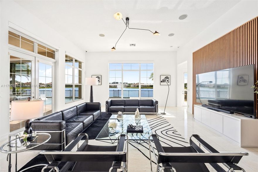 Now available—an exceptional, designer-renovated lakefront home in gated Sterling Ranch. This 4 bd+den|4.5 bth entertainer’s dream boasts one of the community’s largest backyards, complete with a heated saltwater pool, spa, sun ledge, vibrant lit fountains, and motorized patio screen. Soaring ceilings and abundant natural light enhance the warm, modern open layout with a chef’s kitchen, oversized island, custom cabinetry, and premium appliances. Other feautures include a 500-gal propane tank, whole-house generator & water filtration, impact windows/doors, 14-camera system, indoor/outdoor speakers, bespoke lighting, and expansive custom closets. A rare fusion of style, privacy, & smart living—within view of the iconic guitar-shaped Hard Rock. Close to schools, shopping, beaches & highways.