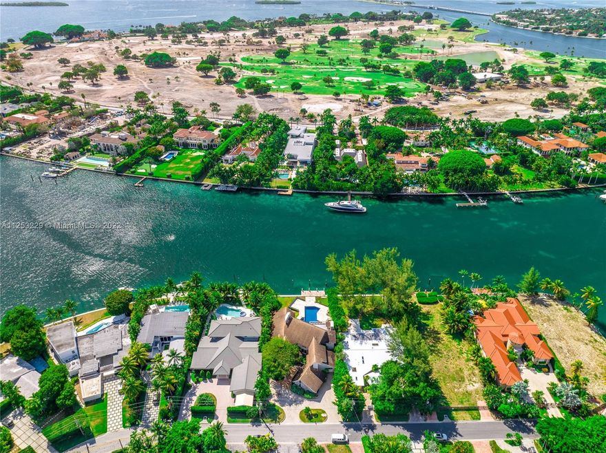 This architecturally unique 6,600 SF home was designed by Barry Sugarman and sits on an oversized 18,400 SF lot with 92 LF on the water. It has soaring 25’ ceilings, large living spaces, massive terraces, and stunning views of a wide waterway and Indian Creek Island. It also has a home theater, office, gym, playroom, and large eat in kitchen that opens up to a patio. The primary bedroom is on the ground floor and features his and hers baths. This beautiful home has impact windows, a two car garage, and a brand new, oversized dock. It’s the perfect family home on a cul-de-sac, and minutes from the ocean, Bal Harbour Shops, and restaurants.