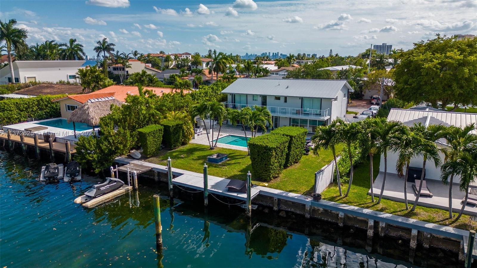 Welcome to your very own boater's paradise in the highly sought-after gated community of Sans Souci. This charming two-story home boasts 75 feet of water frontage and no fixed bridges. Step inside and experience the spacious open Italkraft kitchen and large family room. Retreat upstairs to the expansive second-floor master suite, featuring a private open terrace overlooking the stunning water views. Situated on a generous 9,375 SF lot, this home offers a beautifully manicured backyard, complete with a covered barbecue area, a sparkling pool, a sun deck, and a cozy fire pit. All windows and doors are impact resistant. Take advantage of this rare opportunity to own the best-priced property in the highly coveted Sans Souci Estates.