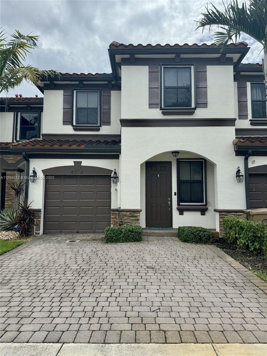 Stunning 3BD/3BA townhome in gated Magnolia Trails. This smart home features no carpet—tile floors downstairs & wood upstairs. Includes Ring doorbell, Alexa-enabled kitchen lights, app-controlled A/C, & electric front door lock. Spacious layout with formal dining, quartz kitchen, full downstairs bath, & large living area opening to a private fenced patio. One-car epoxy garage & 2-car driveway. Upstairs: master suite with custom closets, 2 bedrooms, & full bath. Accordion shutters & tankless water heater. Community includes pool, guest parking, & lush landscaping.