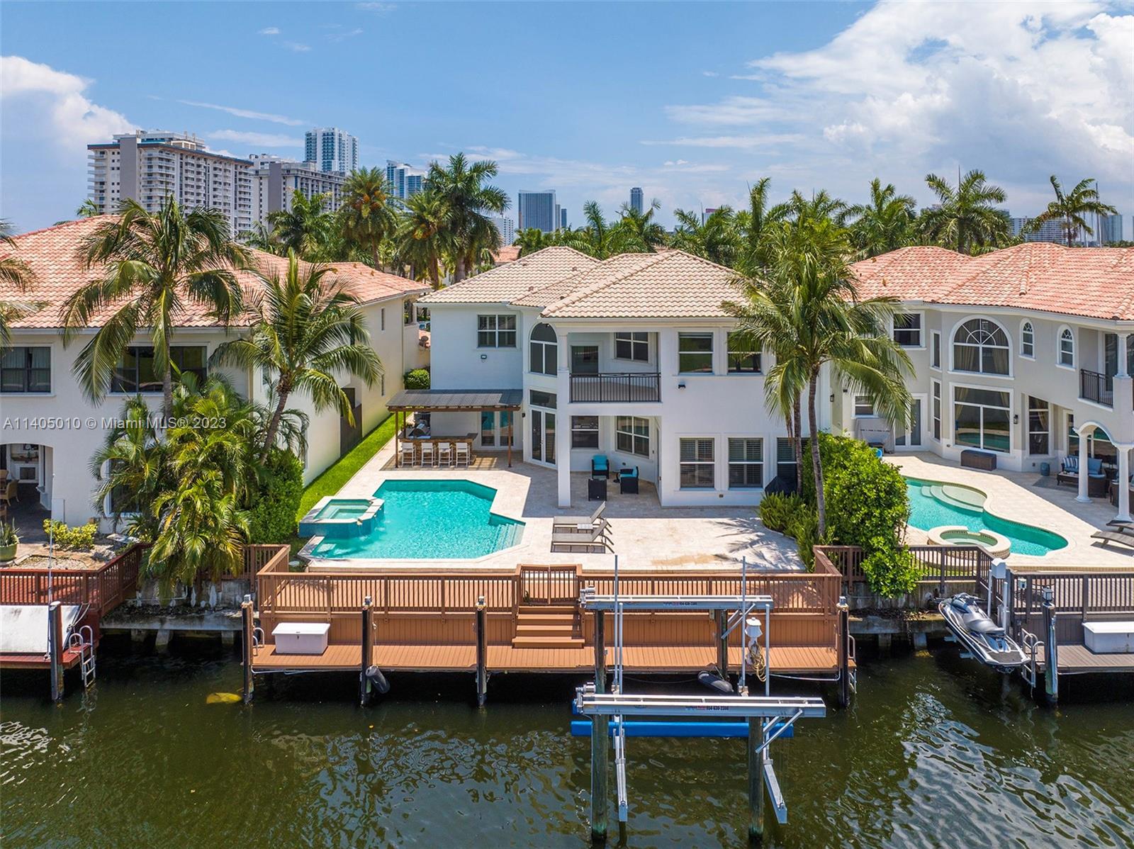 Waterfront home in Harbor Islands gated community. This 2-story Fortaleza home offers 5BR/4.5BA, all impact windows/doors. Enjoy breathtaking views, a heated pool, summer kitchen, and easy access to all the community amenities. With a 24k lbs. boat lift, ocean access, no fixed bridges and deep water, boating enthusiasts are sure to love it here. This family-friendly oasis is perfect for entertaining and creating lasting memories with convenient central location between Miami and Fort Lauderdale. Don't miss this chance to own a piece of paradise. Community amenities include clubhouse, gym, tennis courts, community pool, 40-acre park, private marina and more.