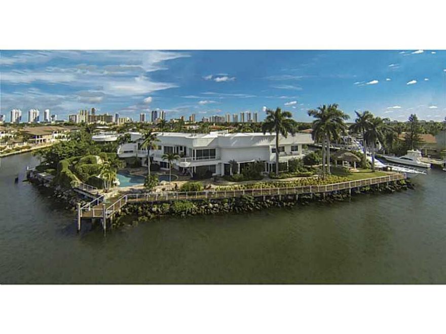 A combination of eclectic design and elegant taste is met from this beautiful 9,340 sq. ft. home.  This private & gated splendor is accentuated by high ceilings & dazzling Maule Lake views from every corner. 2 separate wings, each with their own stairway,  transforms this home to a family's haven. Home features large dining & living room areas, bar, wine room & cellar, game room, media room, & a beautiful backyard with nature-inspired pool, Jacuzzi, gazebo, basketball court & private dock.