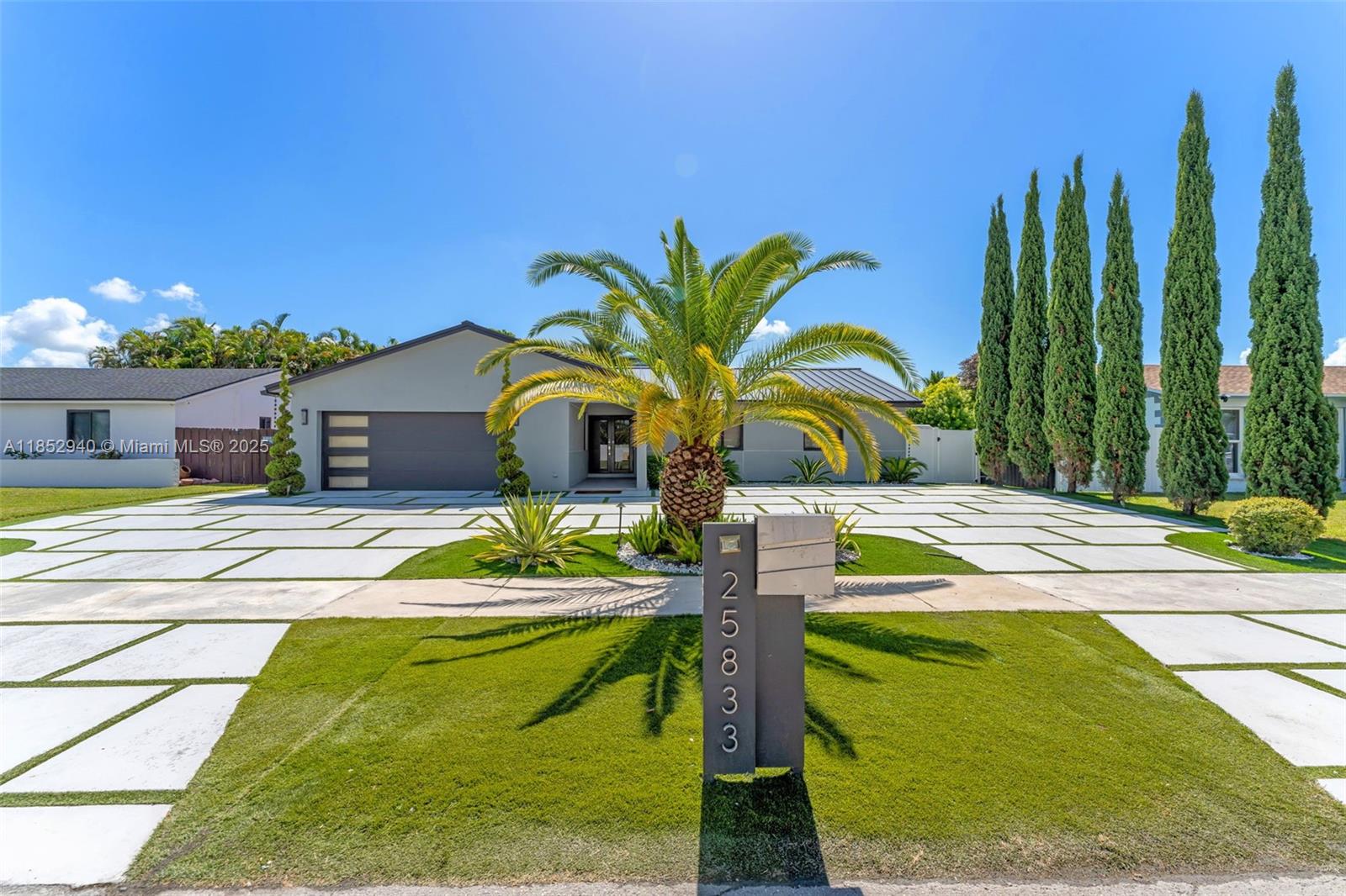 From the moment you arrive, this beautifully 4 BR/ 3 BA home makes a lasting impression with its stunning curb appeal & unique grass paver driveway. Inside, an open-concept layout showcases modern finishes, including a chef inspired kitchen with quartzite counters, a cooking island & sleek stainless appliances. Spa-like baths feature marble finishes, while the converted garage offers a versatile den or family room. Custom doors, elegant LED lighting, and upgraded details offer a touch of sophistication throughout. Step outside to your own private tropical oasis-complete with oversized heated pool, Jacuzzi & fully equipped outdoor kitchen, perfect for entertaining or unwinding under the stars. With a brand-new metal roof & impact windows for peace of mind, this home is truly move-in ready.